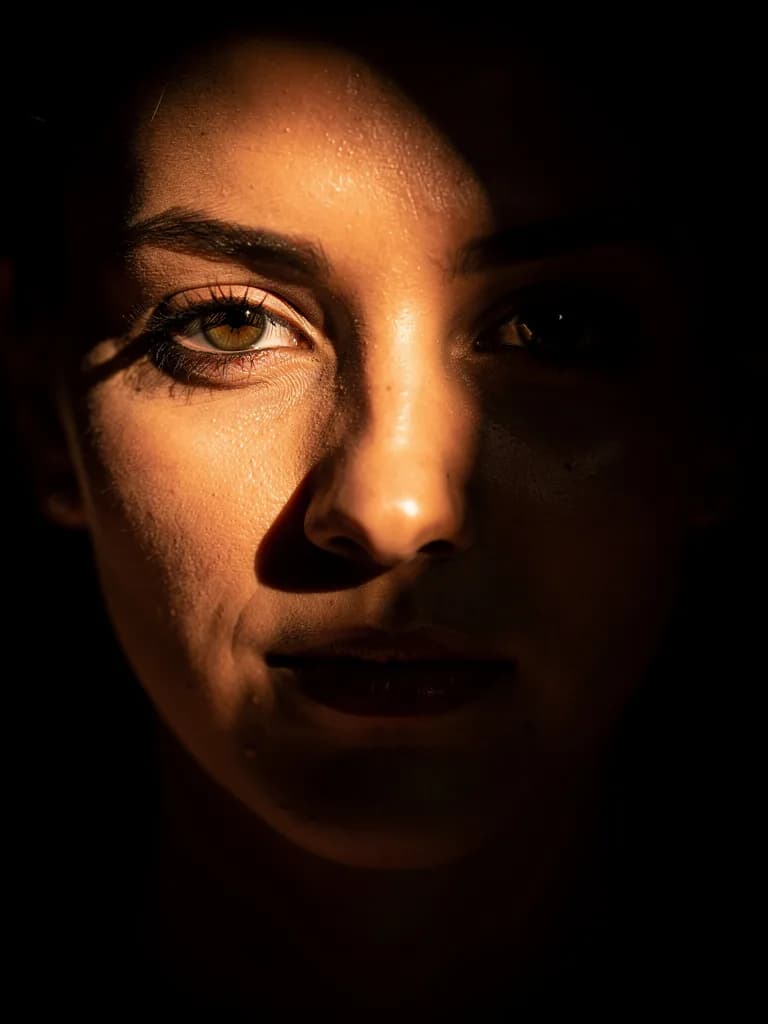 Close-up portrait with dramatic chiaroscuro lighting